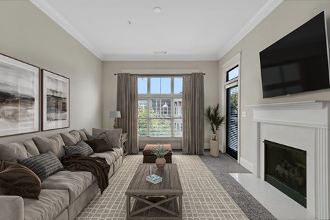 a living room with a couch and a coffee table and a fireplace